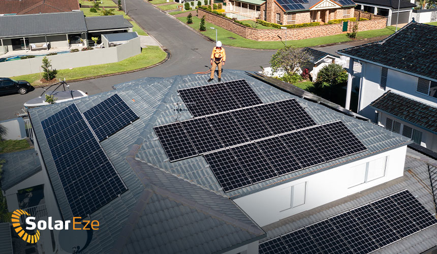 Gold coast solar installer standing on roof after installing a solar system